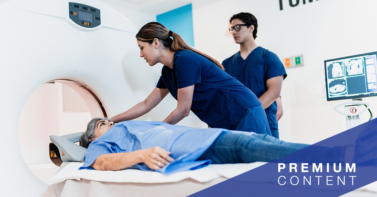 Female nurse talking while preparing patient for a tomography exam at hospital